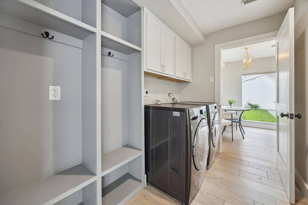 Conveniently located just off the kitchen, the combined mudroom and laundry room offers direct access to the garage. With thoughtful built-in storage, this space adapts easily to your daily routines and organizational needs.