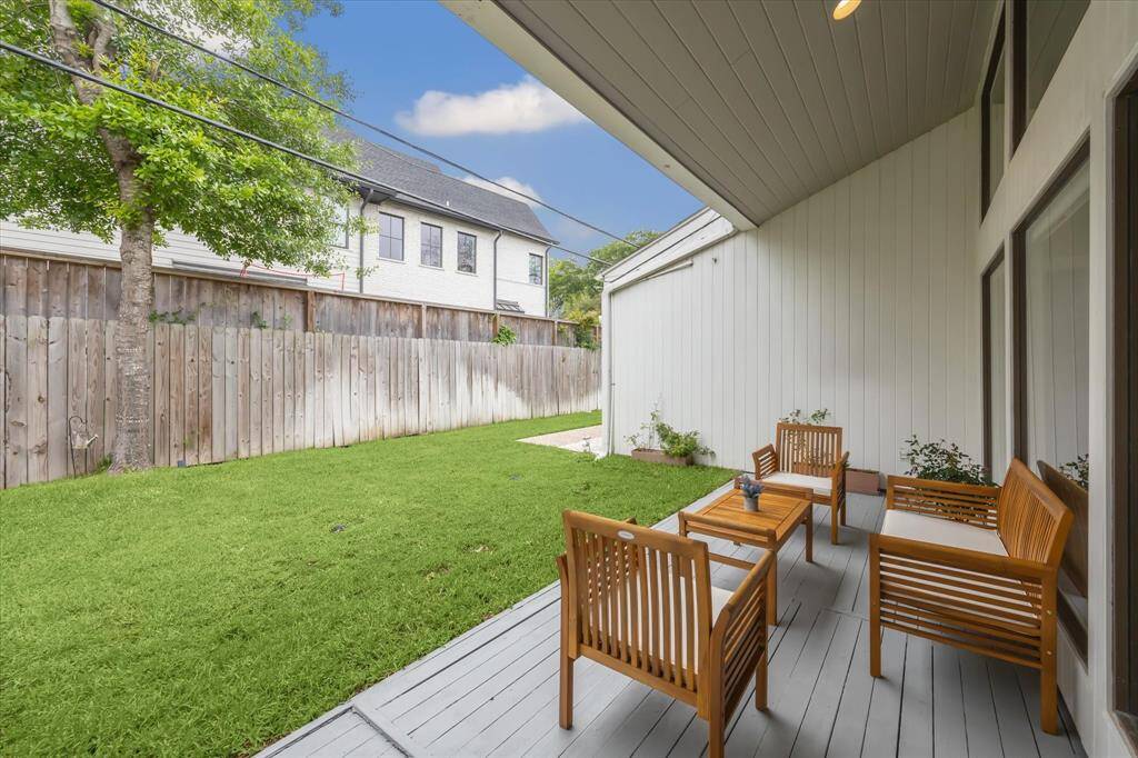 The covered backyard patio exudes a calm, serene ambiance.