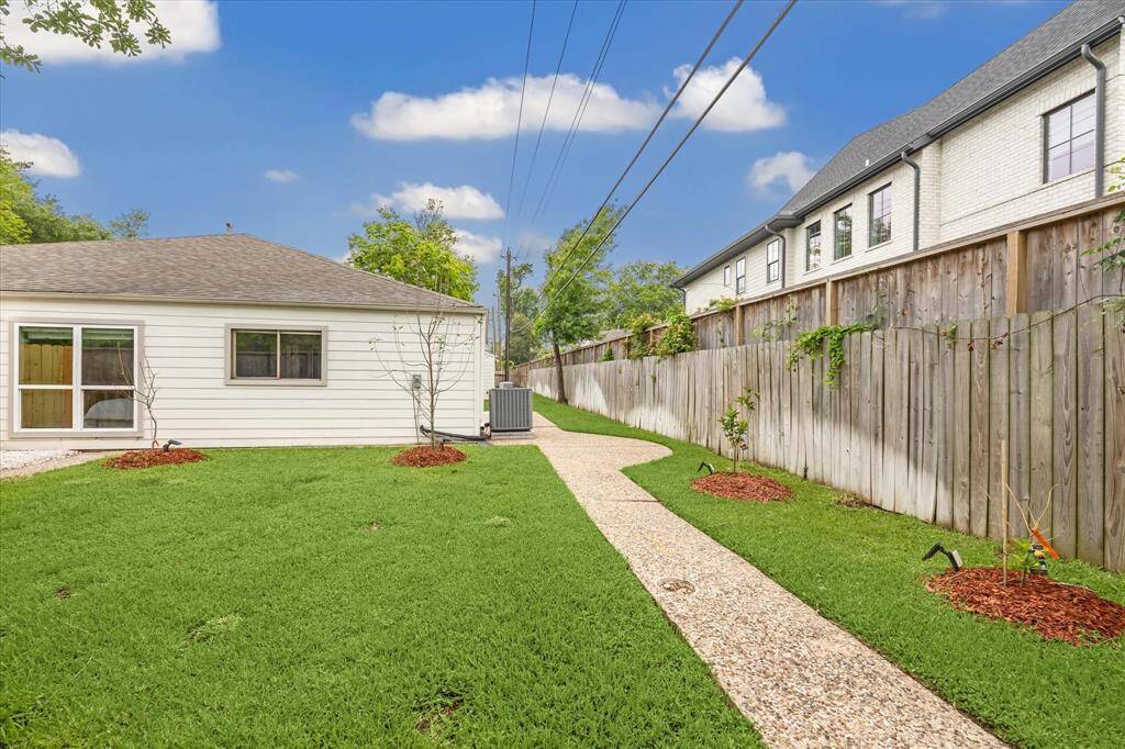 A view of the north side of the yard highlights a thoughtful row of young fruit trees—apple, peach, mandarin, and blood orange—planted with care for the seasons ahead. With a little patience, these saplings will flourish and bear fruit in the years to come.