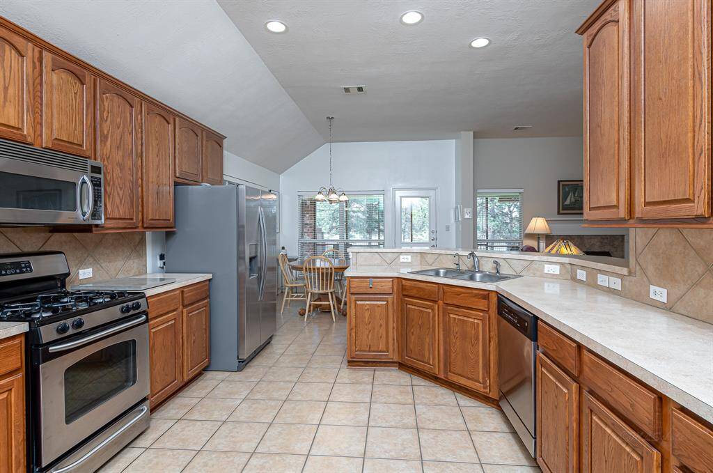 This alternate kitchen perspective emphasizes its spaciousness, while also highlighting the picturesque pond view that enhances the culinary experience.