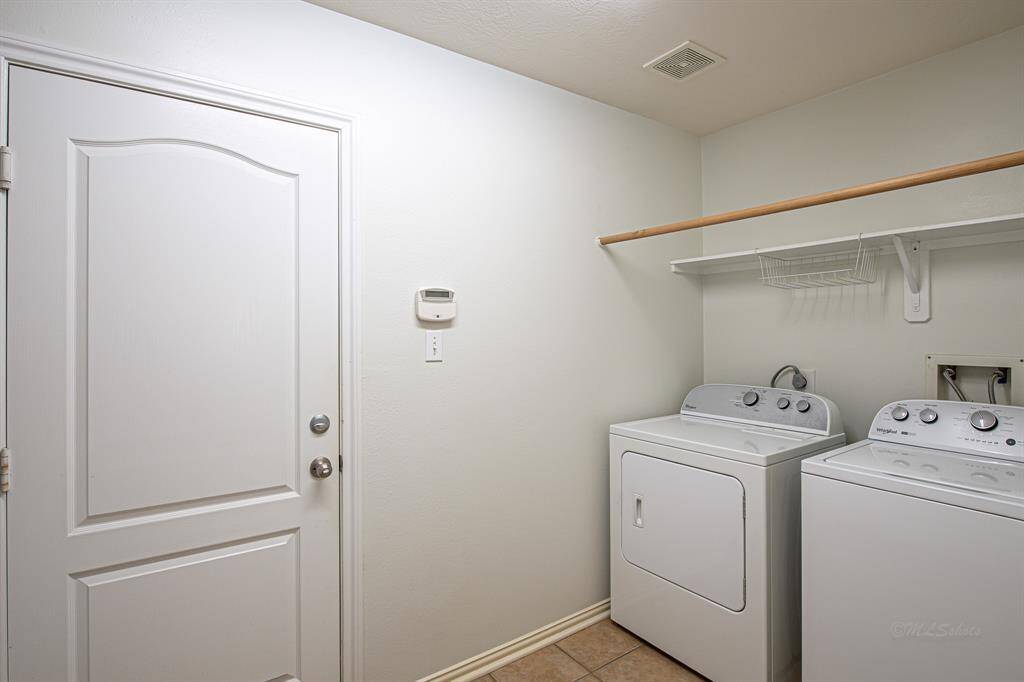 The utility room is spacious and offers ample storage space. Additionally, there is a significant amount of space to the left of the garage door that could be easily converted into a mudroom or used for additional storage.