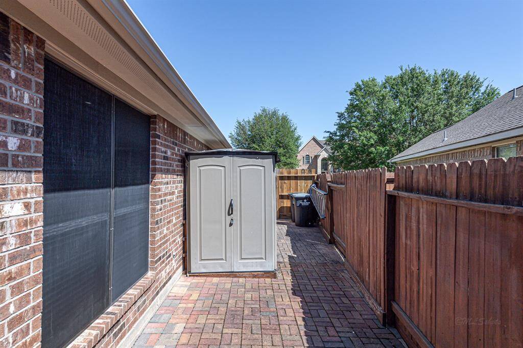 A dedicated and tidy area provides convenient storage for your shed and trash cans, complete with a utility sink behind the shed for added practicality.