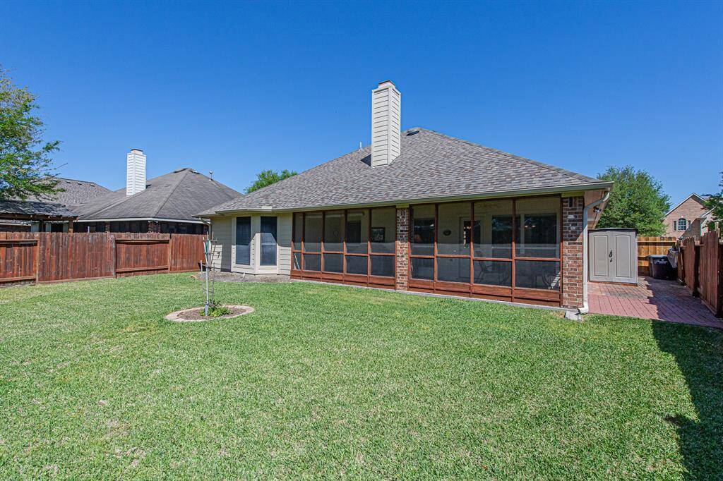 The expansive screened porch stretches nearly the length of the house, providing ample space for outdoor enjoyment. This well-maintained home offers year-round comfort and a generous yard.