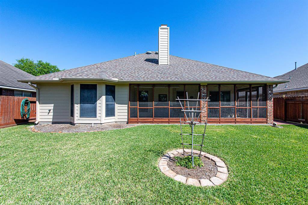A view of the home from the back yard, showcasing the expansive screened in porch where you will spend much of your time in the near future!