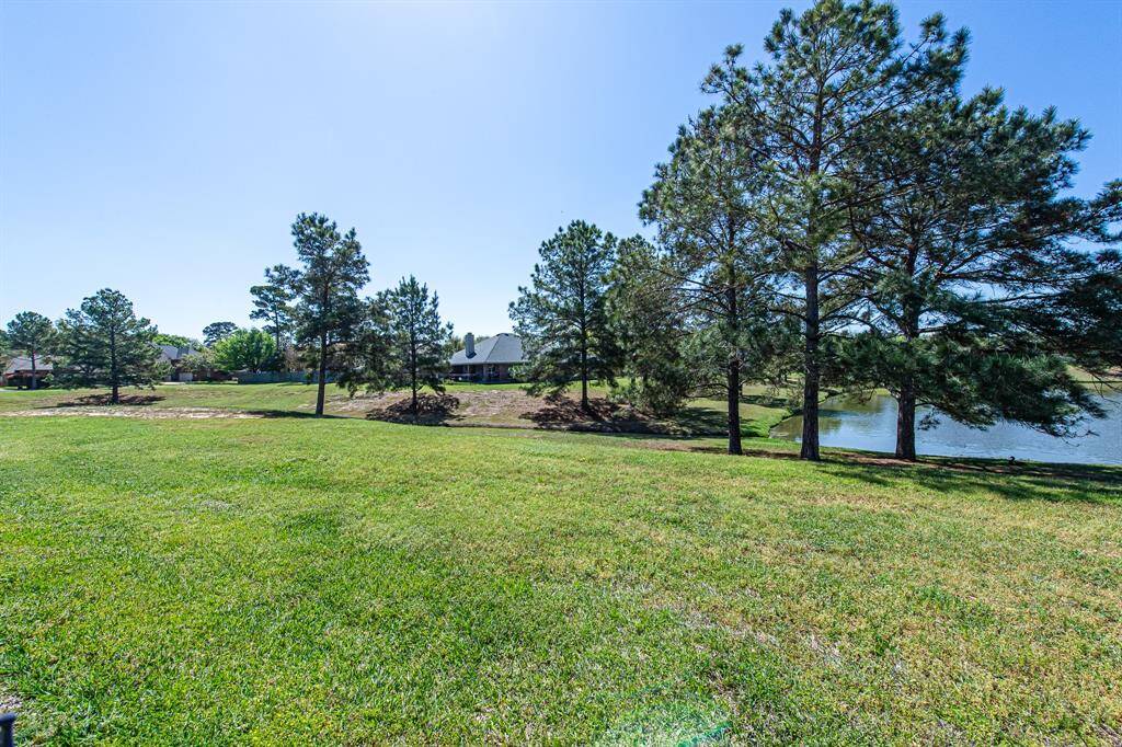 Tranquil pond views meet open green space, flowing to a picturesque canal lined with mature trees. This serene setting offers a perfect blend of natural beauty and peaceful living.