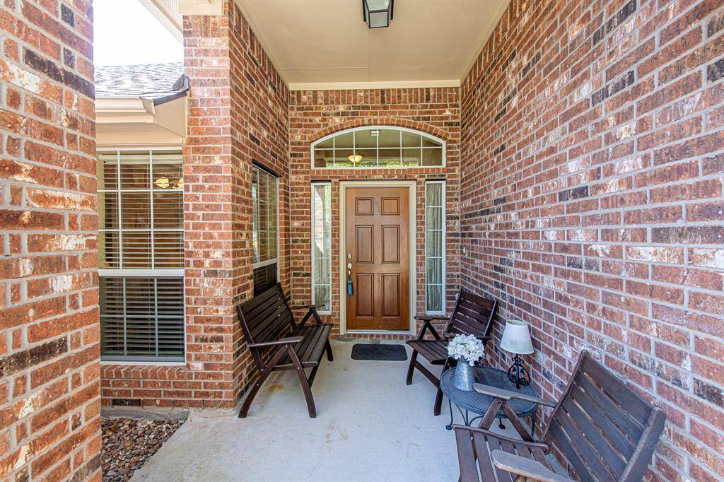 Charming brick front porch offers a great space for your outdoor seating and enjoyment!