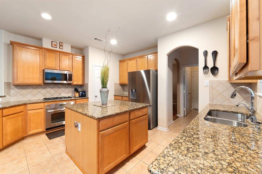 Generous counter space with a window over the prep area allows natural light to brighten the kitchen while you cook.