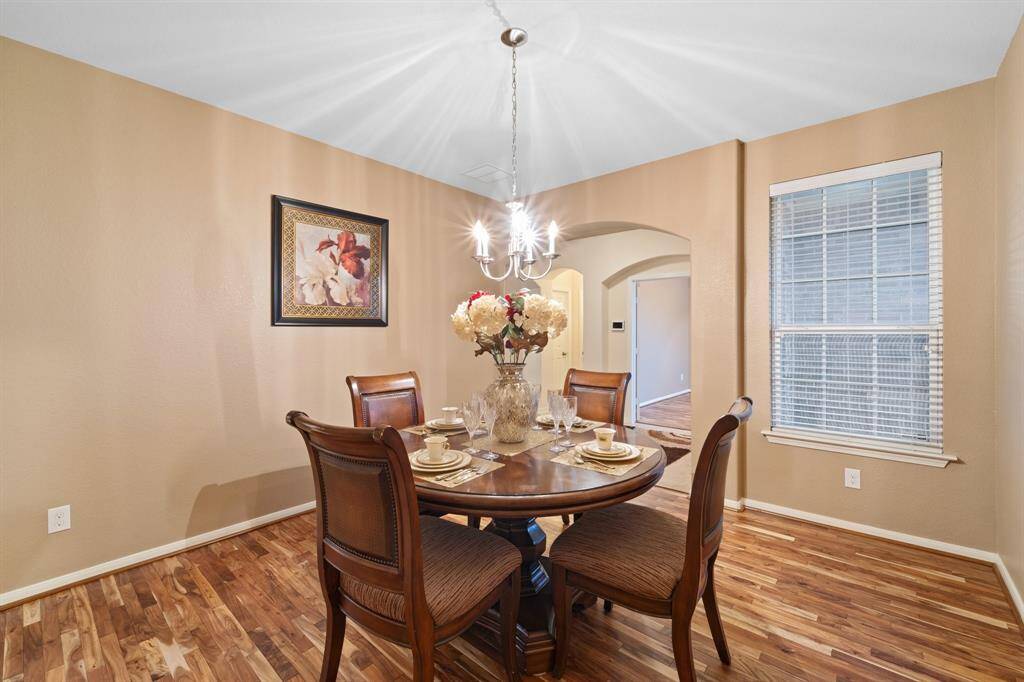 Another angle of the spacious dining area highlights the natural light from the side window and the flow into the main living spaces.