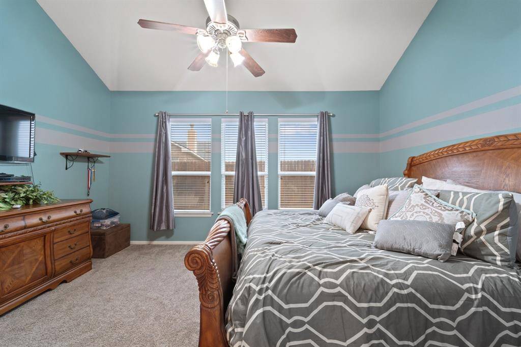 Another view of the primary bedroom showcases the serene paint tones, ample wall space, and room for your favorite furniture pieces.