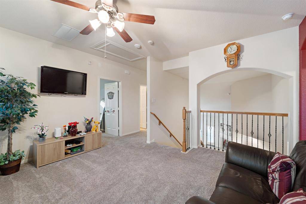 Flexible upstairs living space with natural light and neutral tones—ideal for a playroom, fitness corner, or secondary gathering space.