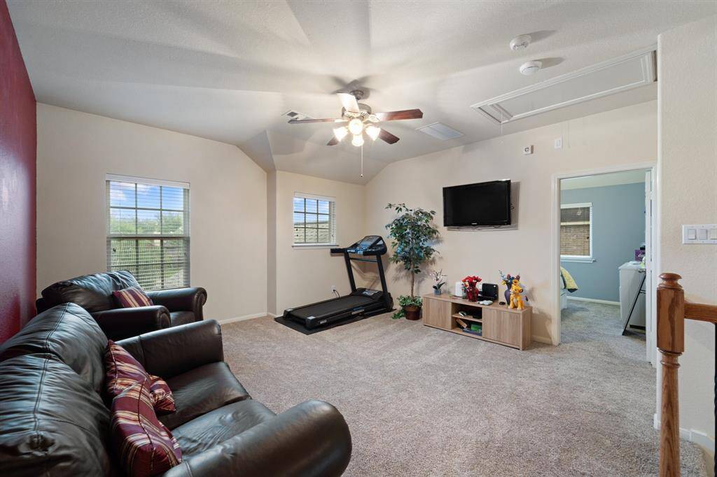 Open-concept layout with plush carpeting and easy access to secondary bedrooms and the media room.