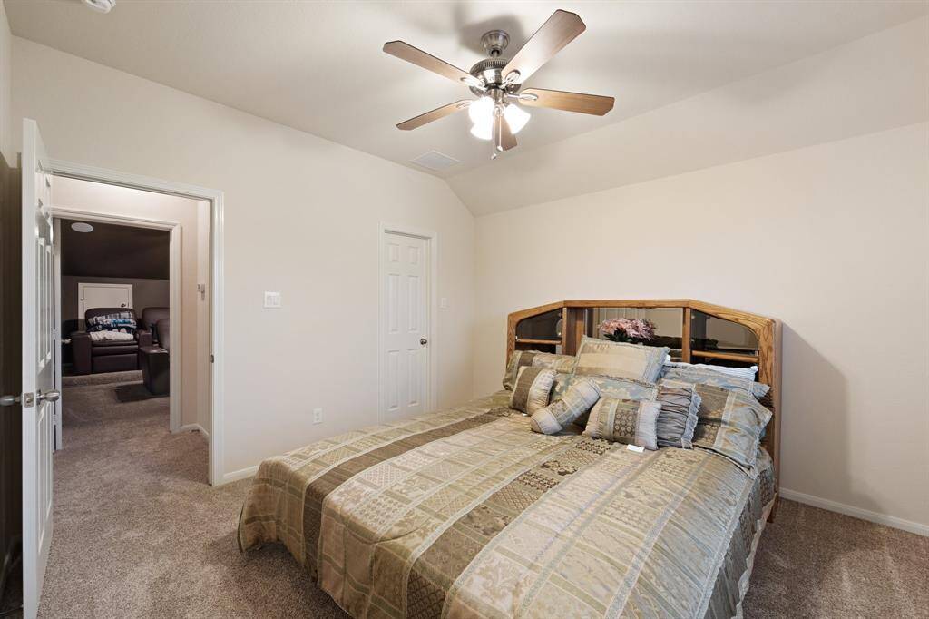 Alternate view of the secondary bedroom showcasing easy access to the media room and a spacious layout.
