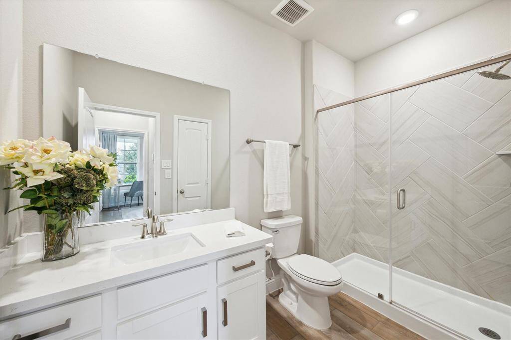 First floor guest bathroom featuring an upgraded walk in shower.