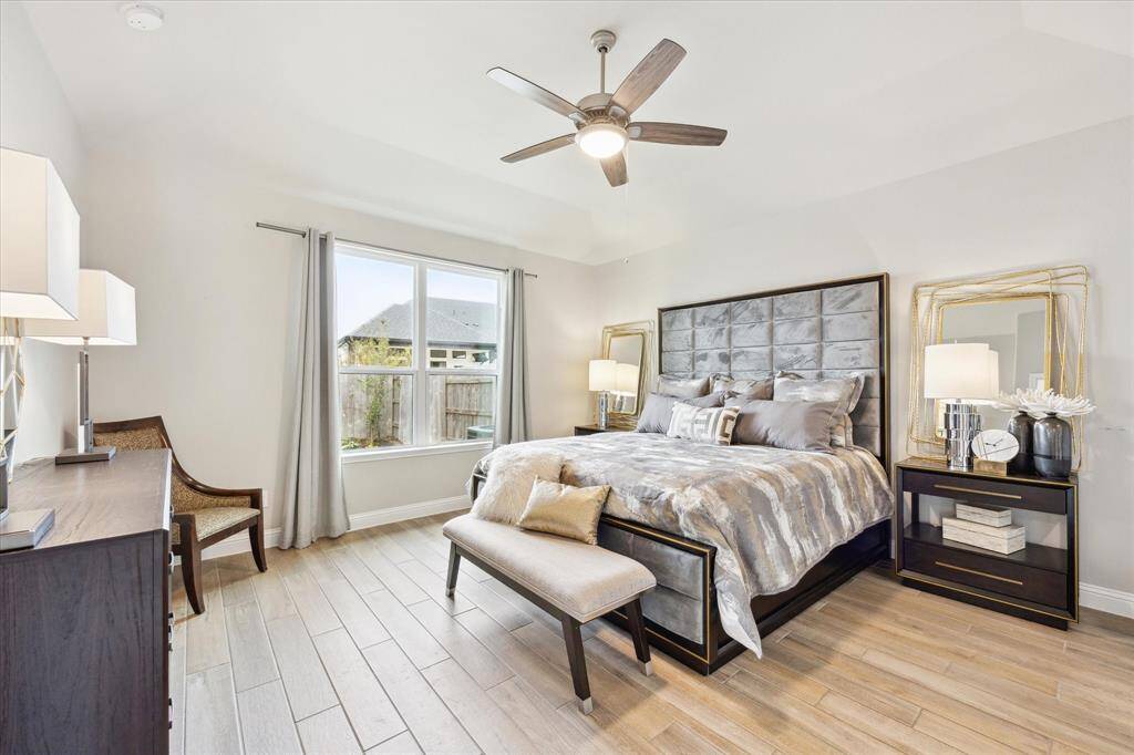 Spacious primary bedroom with a view to the large back yard.