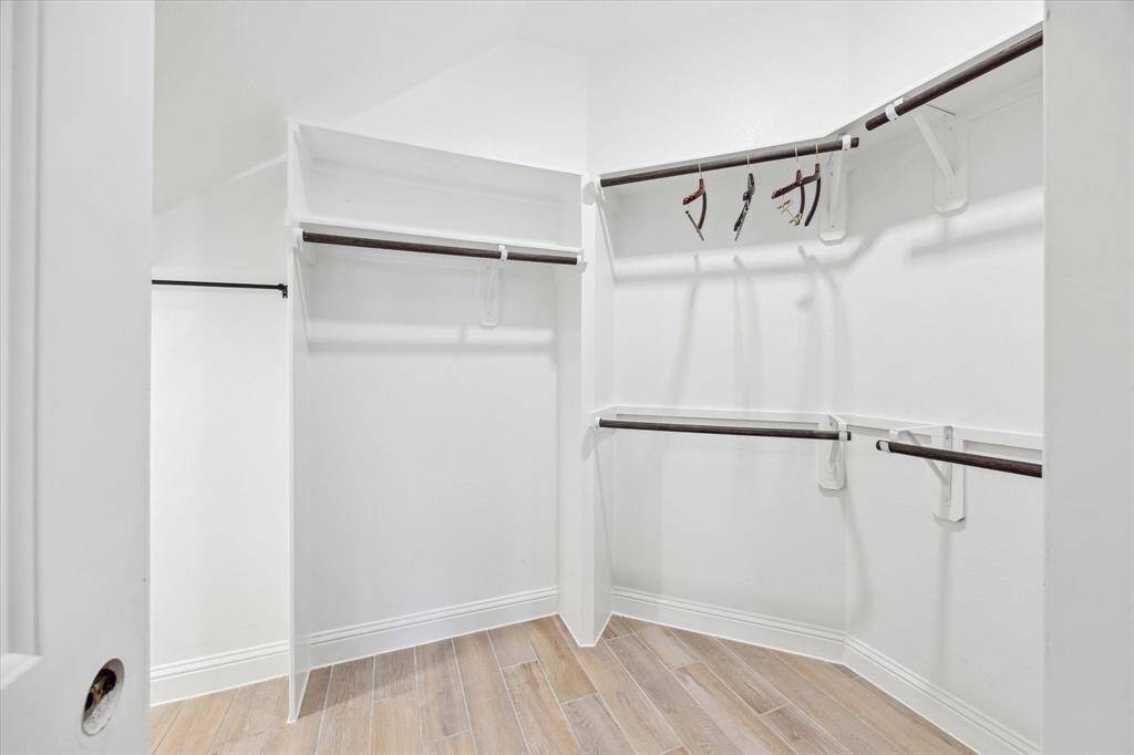 Primary closet with lots of built-ins and storage space.