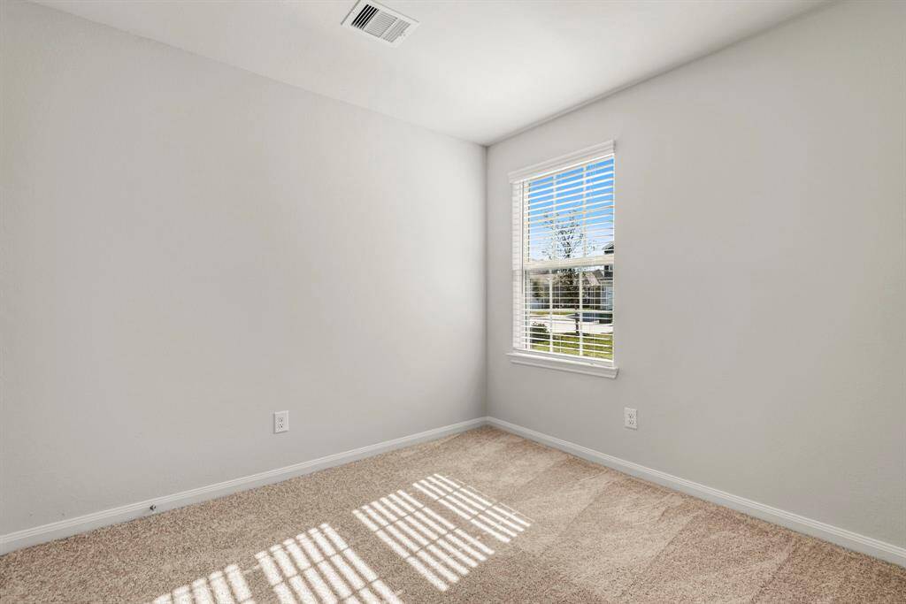 One of the two additional bedrooms in the home.