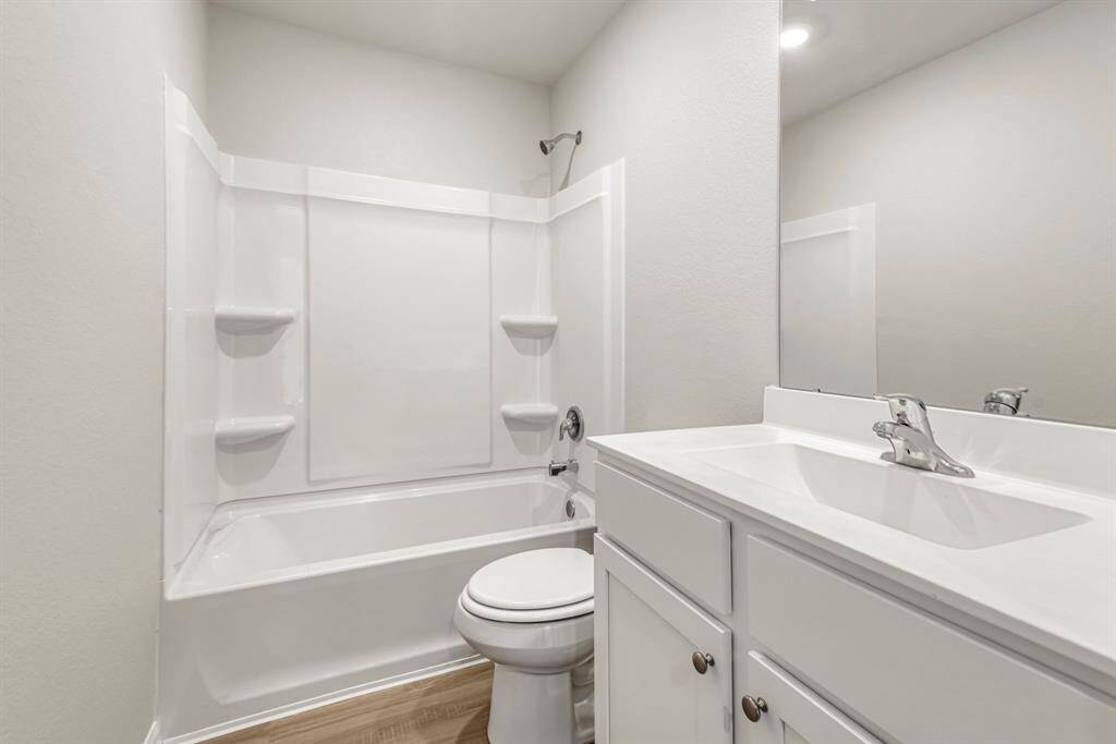 The secondary bathroom, located centrally in the hallway of the home.