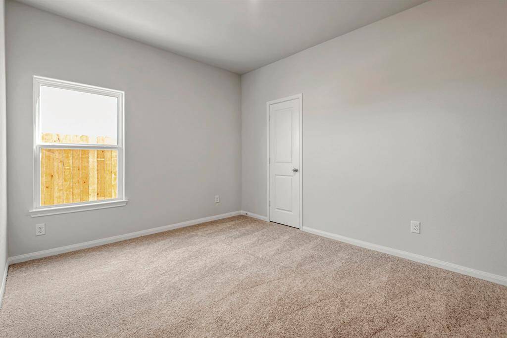 Large, primary bedroom with beautiful windows.