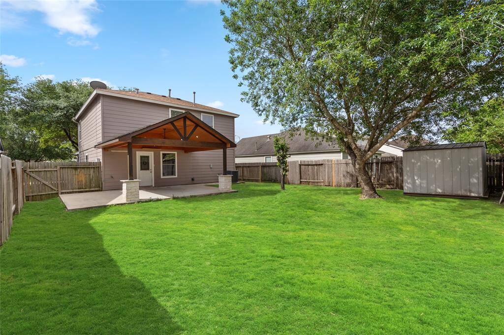 Your new backyard has a mature tree and  patio with a wood-accented cover. The area is fenced providing privacy and includes a storage shed perfect for outdoor activities and gatherings.