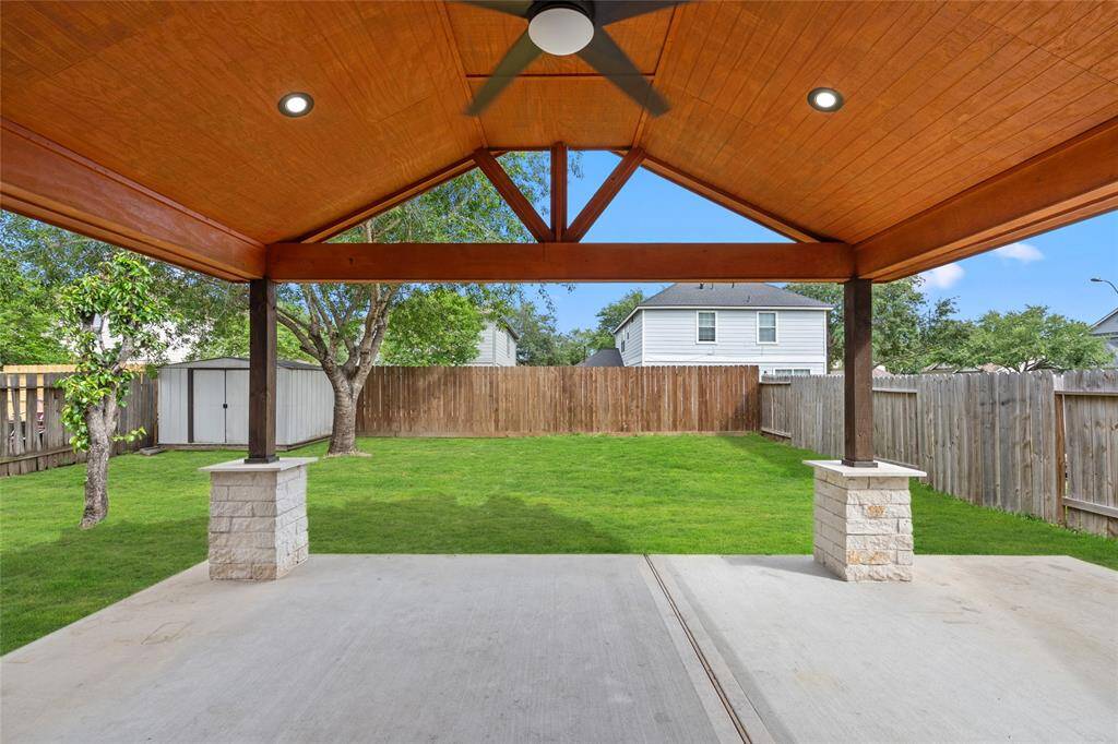 Your large covered patio with a vaulted wood ceiling and built-in lighting is perfect for outdoor entertaining.