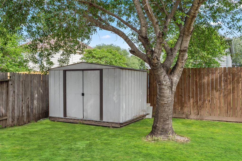 Your backyard included a convenient storage shed located under a large tree.