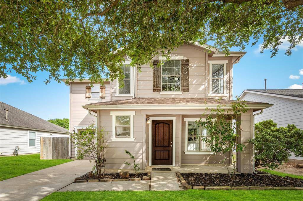 Your new home features a welcoming front porch. The exterior is painted in neutral tones with decorative shutters and a dark front door offering a cozy and inviting appeal.