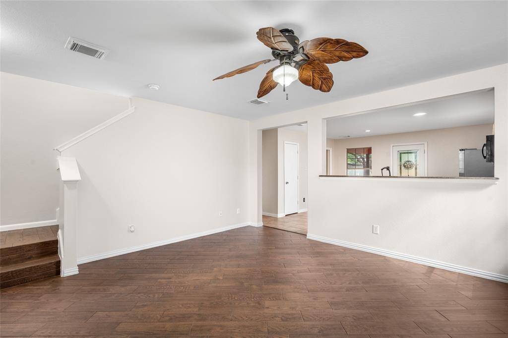 Another view of your living room highlights the neutral color palette and tile flooring.