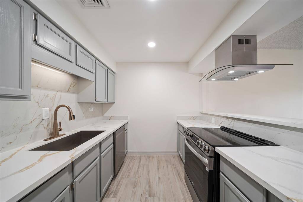 Warm and inviting Galley Kitchen, fully updated and modernized with beautiful Quartz countertops.