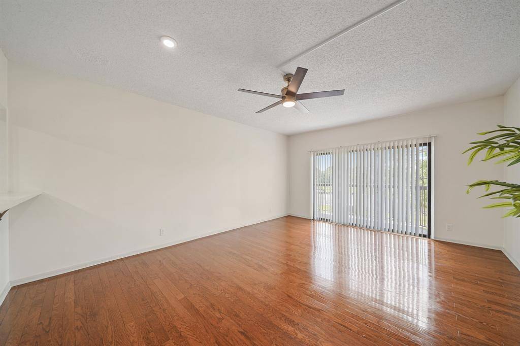 The windows and sliding glass door overlook the front of the condo complex.