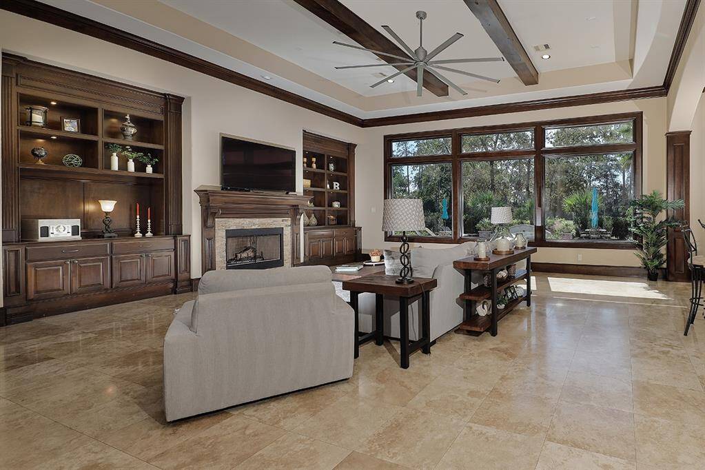 Spacious family room with custom built-in cabinetry and wood beam ceilings