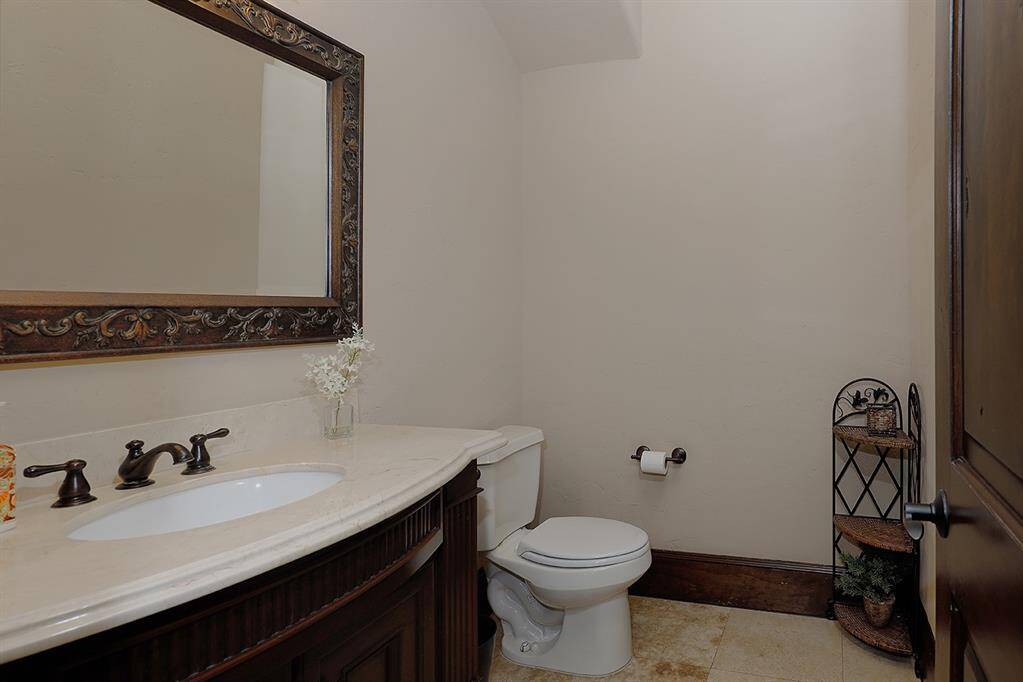 Guest 1/2 bathroom. There is also an additional 1/2 bath with pool/backyard access
