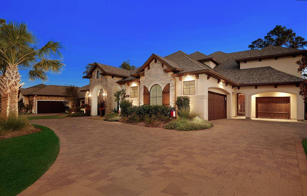 Recently installed driveway and updated lush landscaping