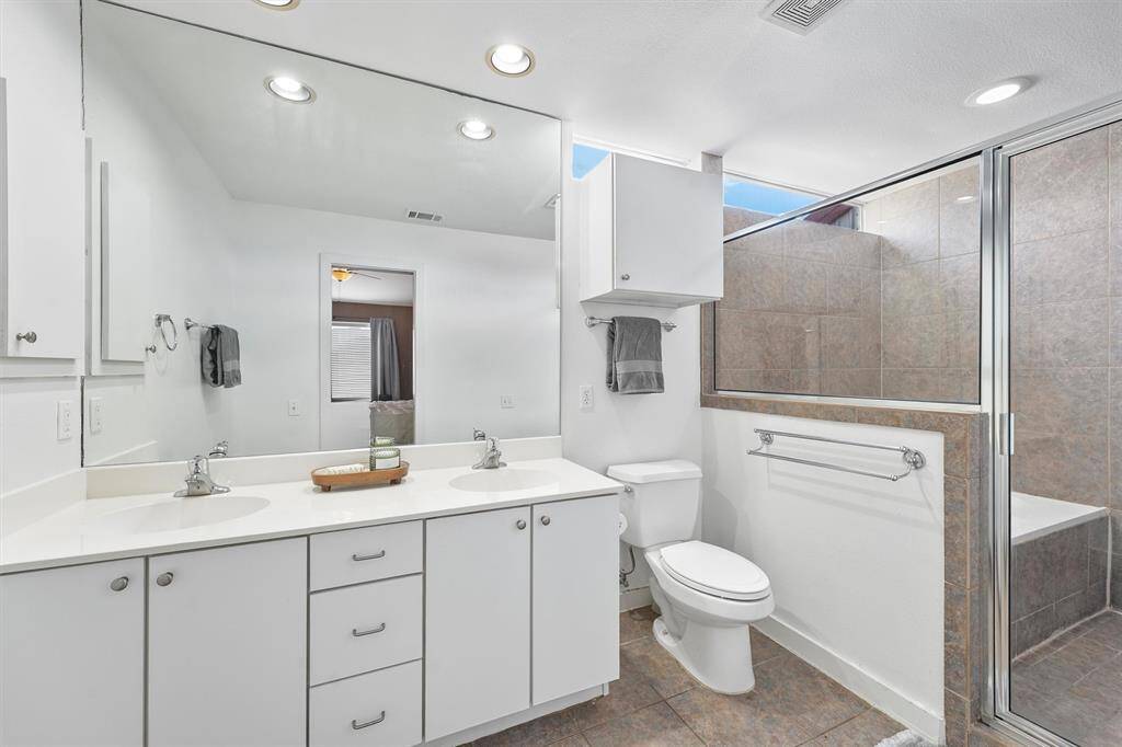Primary bathroom features double-sinks, soaking tub and separate shower.