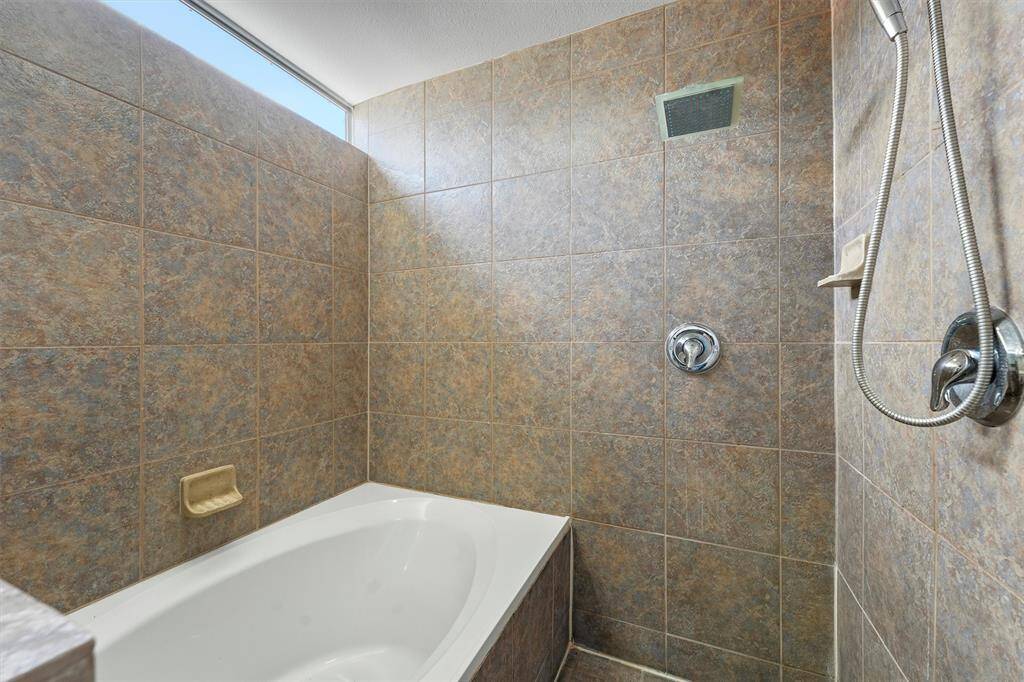 Soaker tub and shower with natural light.