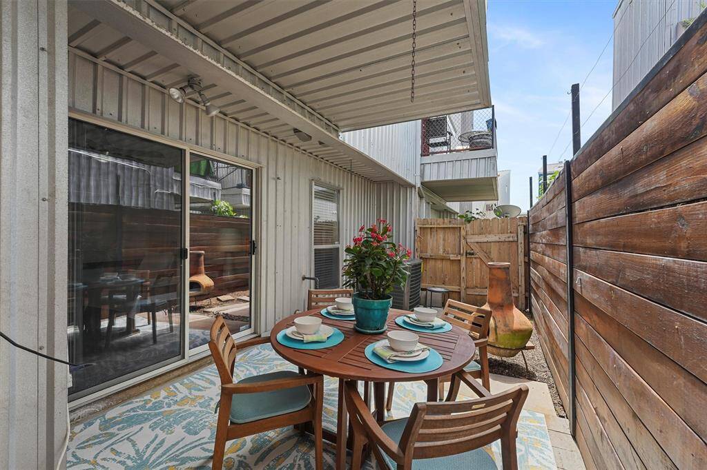 Step out onto the patio. The wood fence was added for privacy. The HVAC was replaced in 2022 (external unity) and 2023 (air handler), per seller.