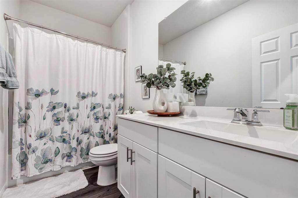 The secondary bathroom is complete with a shower/tub combo and plenty of counter space.