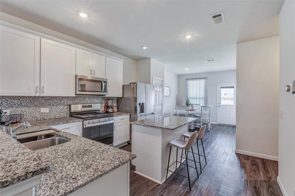 The bright and airy kitchen with plenty of cabinetry and counter space for all your favorite recipes.
