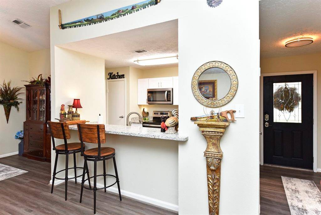 Bar stools looking into kitchen