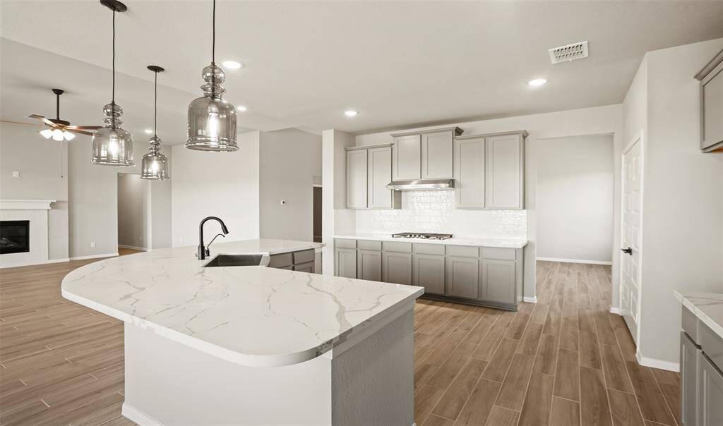 Stylish kitchen with quartz countertops and designer cabinets (*Photo not of actual home and used for illustration purposes only.)