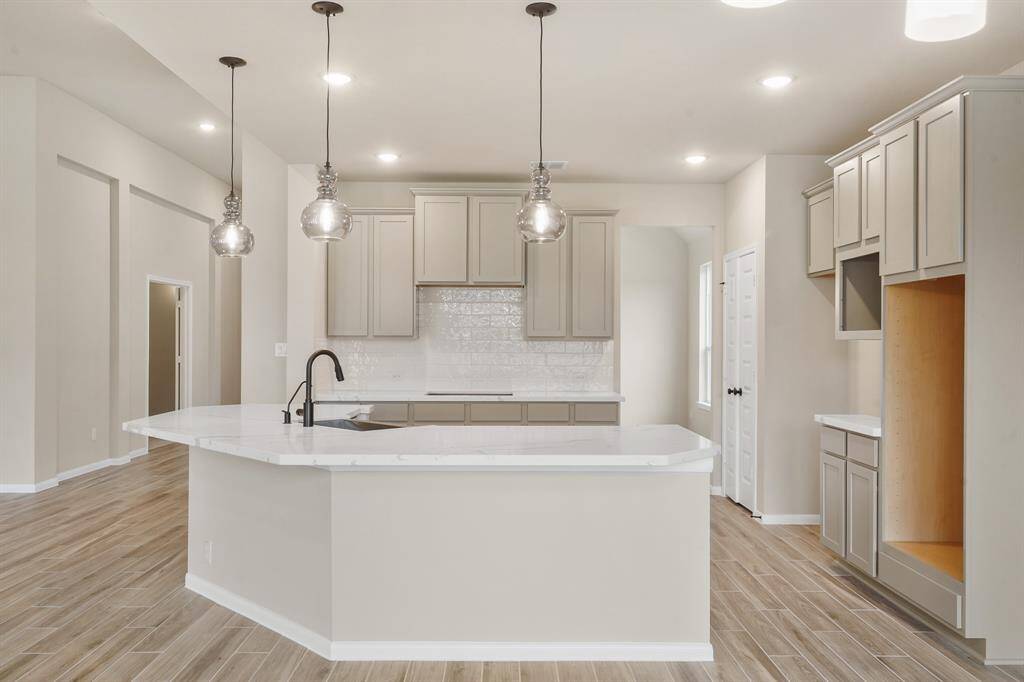 Gourmet kitchen with curved island (*Photo not of actual home and used for illustration purposes only.)