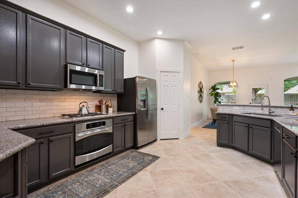 The layout allows for easy access to the refrigerator, pantry, and sink from the cooking area, ensuring efficiency and flow for meal preparation.