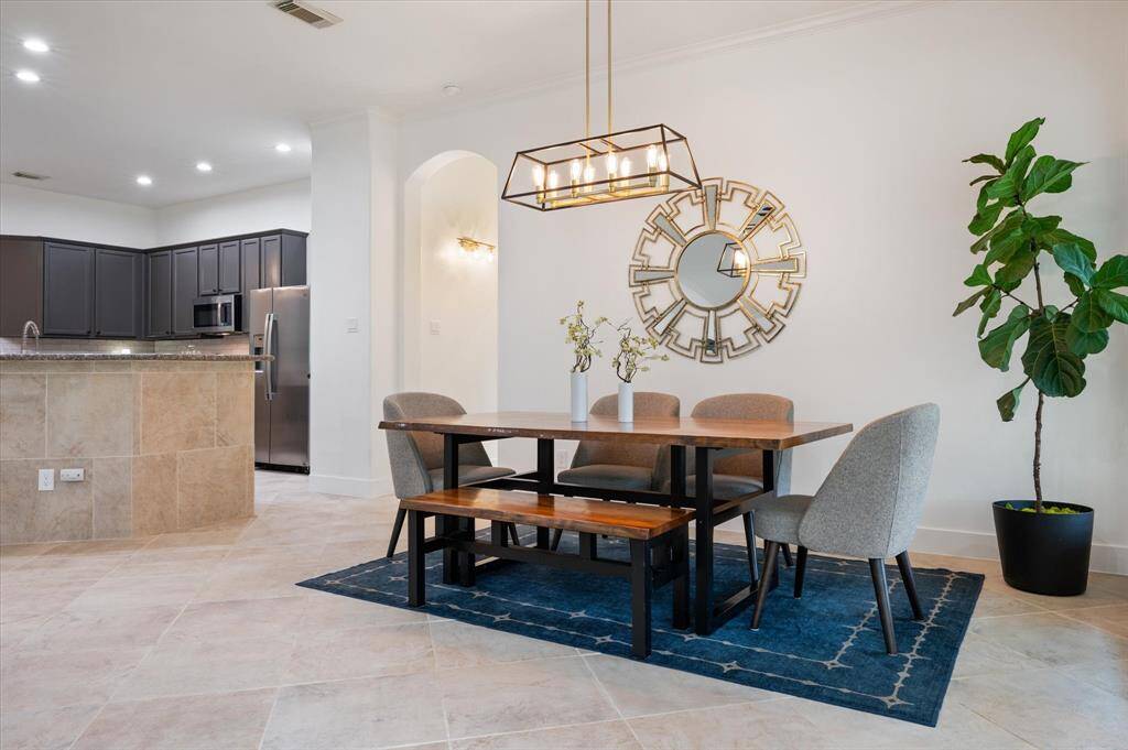 The seamless flow between the dining, kitchen, and living areas creates an ideal space for hosting gatherings. This open layout allows for effortless interaction with family and guests while preparing meals. Ample space accommodates a large dining table and chairs, perfect for entertaining.