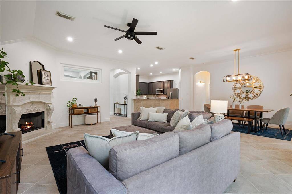 Additional features include elegant tile flooring, recessed lighting, designer paint tones, and an updated ceiling fan, all contributing to the room’s stylish and functional appeal.