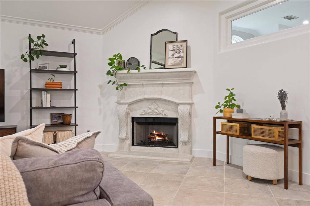 Unwind beside the cozy gaslog fireplace, which doubles as a striking focal point with its custom surround and elegant mantle—adding warmth, charm, and artistic flair to the living space.