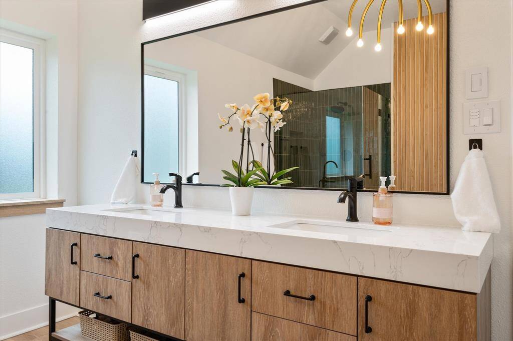 A closer look at the gorgeous vanity reveals ample cabinetry and drawers, providing convenient storage for all your toiletries and essentials.