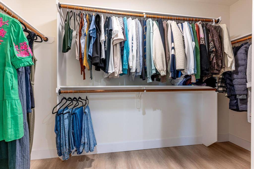 The expansive walk-in closet offers ample hanging space and built-in shelving, perfectly designed to accommodate your full year-round wardrobe with ease and organization.