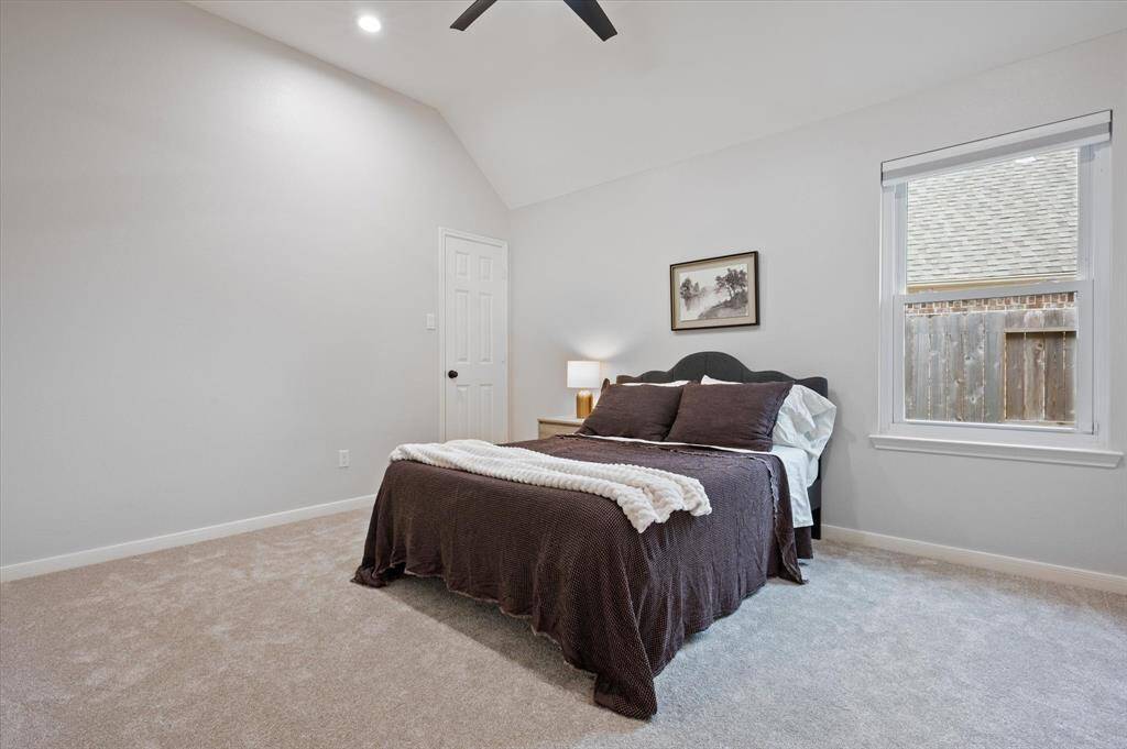 The second guest bedroom carries forward the home’s thoughtful design, featuring sophisticated decorator paint and plush carpeting installed in 2025. A roomy closet and a bright window complete this comfortable and stylish retreat.