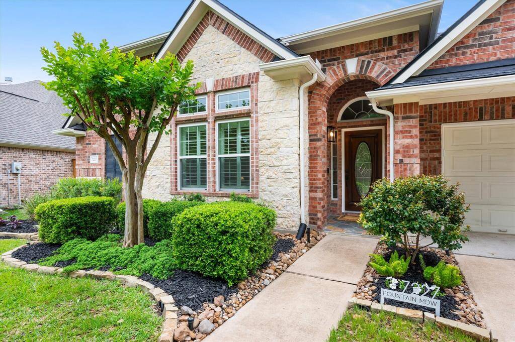 Elegantly designed with a timeless brick and stone exterior, this home boasts a professionally remodeled landscape completed in 2022, featuring a charming stone border and mature, well-curated shrubs. Functional touches like full gutters add to the home’s overall appeal and long-term care.