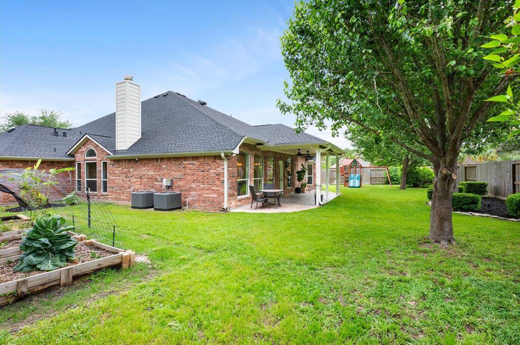 The home is fully equipped with gutters, a sprinkler system, and custom garden beds, all set and ready for you to cultivate your perfect outdoor space.