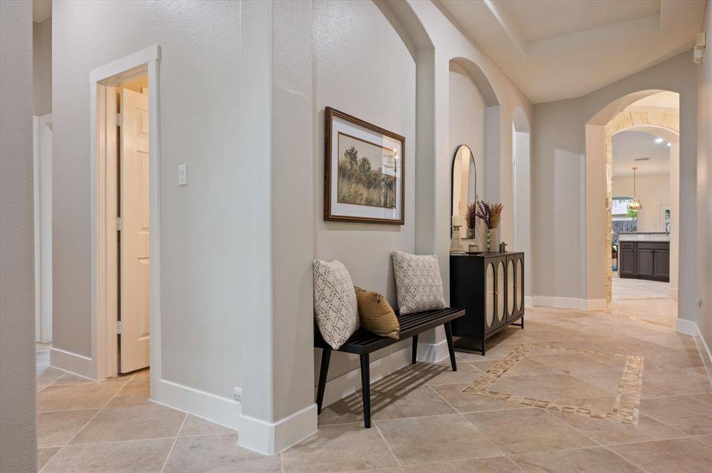 This alternate view of the entryway offers a glimpse into the thoughtfully designed floor plan, highlighting the home's open flow and inviting layout.